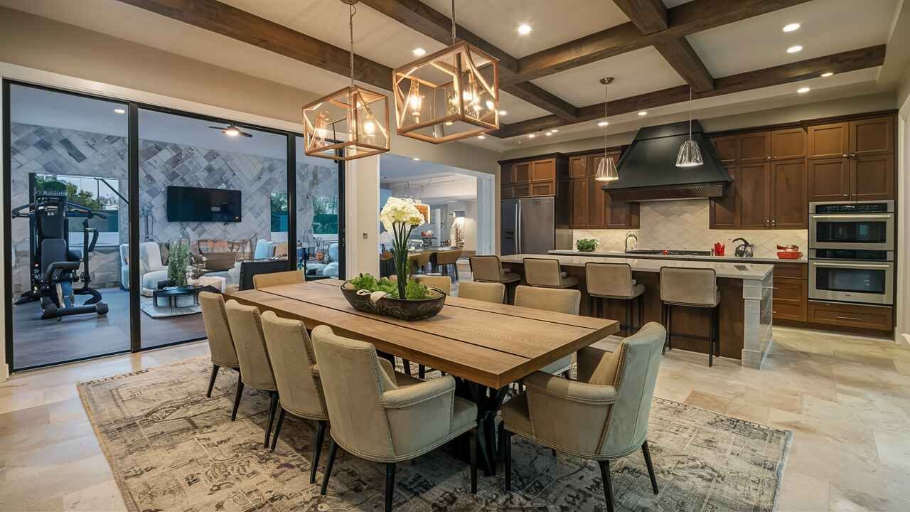 The home features a gourmet kitchen with top-of-the-line appliances, a spacious master suite with a luxurious spa-like bathroom, and a fully equipped home gym.