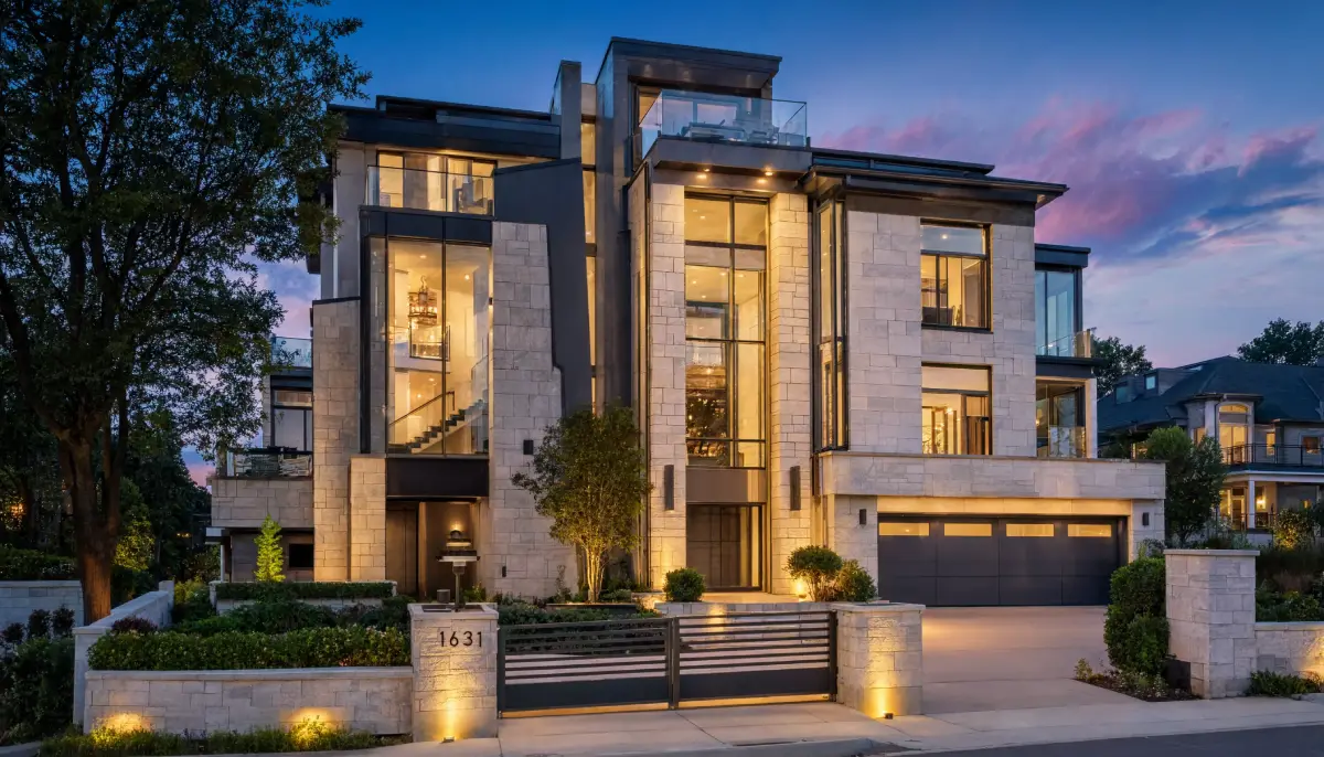Contemporary six story luxury home with a striking stone facade, expansive floor to ceiling windows, rooftop terrace, and dramatic architectural lighting creating a standout presence in the real estate market.