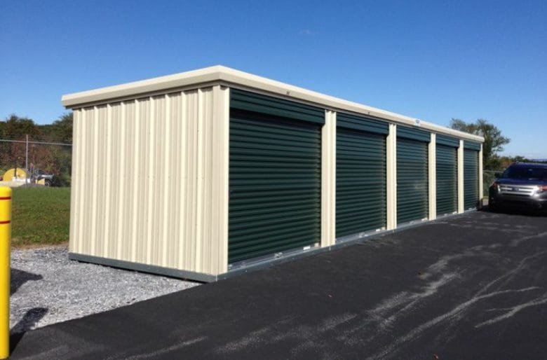 Mobile storage units in San Diego with green roll-up doors on a paved lot.