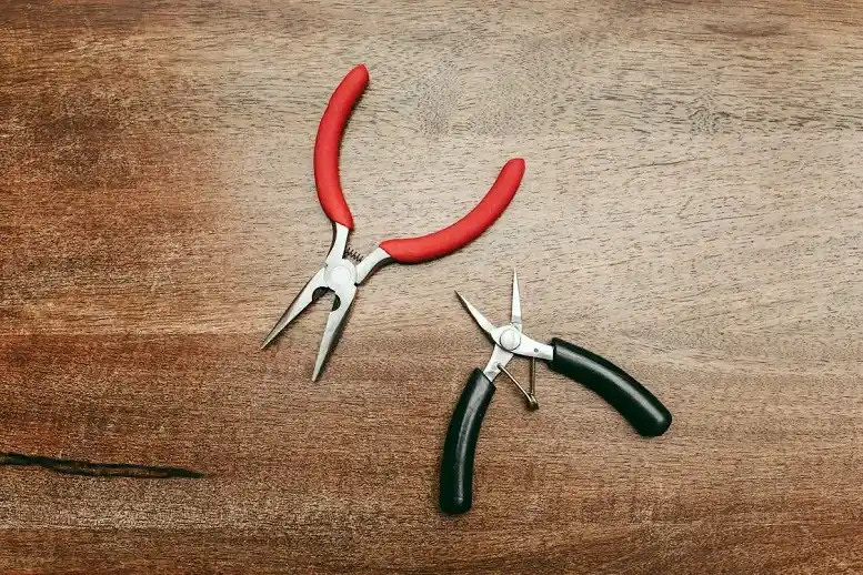 Best DIY Pliers for Homeowners - DIY Projects - Homedecortoday Needle-nose pliers gripping a screw to show tool precision and control