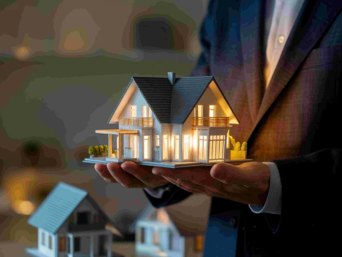 Why You Need a Hampton House Builder Melbourne for Your Dream Home - Building & Construction - Homedecortoday A Hamptons-style house model with construction plans, representing the design and planning process of a Hampton house builder in Melbourne.