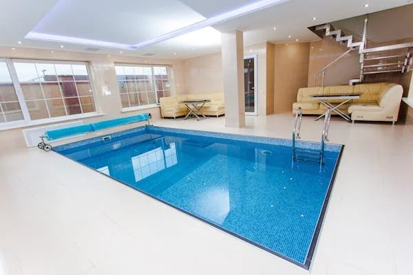 Is a Pool a Good Investment? Smart Reasons to Add Swimming Pools to Your Home - DIY Projects - Homedecortoday Indoor pool creating a perfect family space from a swimming pool investment.