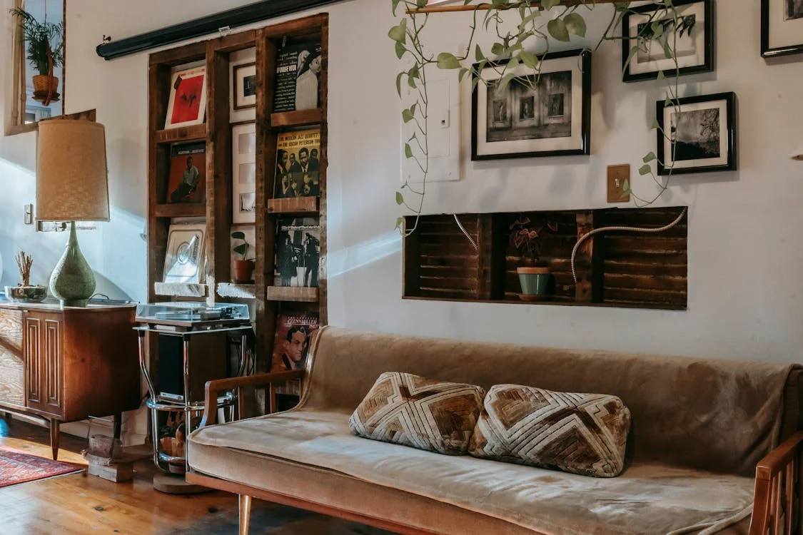 Vintage-inspired living space with a vinyl record collection, a cozy sofa, and warm wooden elements for a nostalgic and stylish vibe.

